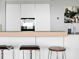 A kitchen with bar stools and countertop at Huxham View & Annex in Kingsteignton