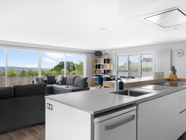 A living room with a sofa and kitchen island at Huxham View & Annex in Kingsteignton