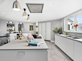 A kitchen with a center island and modern fixtures at Huxham View & Annex in Kingsteignton