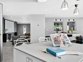 A kitchen with a cooking pot and a cookbook on the island at Huxham View & Annex in Kingsteignton