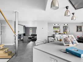 A kitchen with a sofa and television at Huxham View & Annex in Kingsteignton