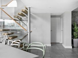 A hallway with a staircase and plants at Huxham View & Annex in Kingsteignton
