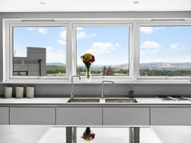 A kitchen with sink and windows showing a view at Huxham View & Annex in Kingsteignton