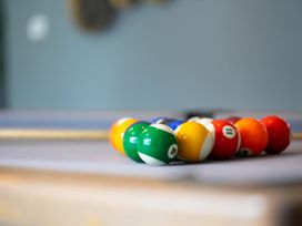 A pool table with a set of balls arranged in a triangle at Huxham View & Annex in Kingsteignton