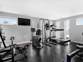 A gym with exercise equipment at Huxham View & Annex in Kingsteignton