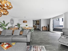 A living room with a sofa and dining table at Huxham View & Annex in Kingsteignton