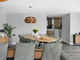 A dining room with a table and chairs at Huxham View & Annex in Kingsteignton