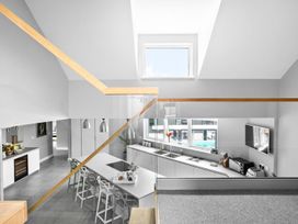 A kitchen with bar stools and a countertop at Huxham View & Annex in Kingsteignton