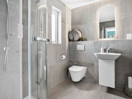 A bathroom with a shower, toilet, and sink at Huxham View & Annex in Kingsteignton