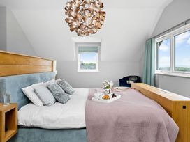 A bedroom with a bed and a bedside table at Huxham View & Annex Kingsteignton