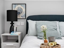 A bedroom with a bed and nightstand at Huxham View & Annex in Kingsteignton