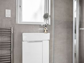 A bathroom with a sink and towel radiator at Huxham View & Annex in Kingsteignton