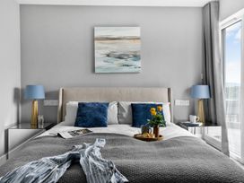 A bedroom with a bed and flowers on a tray at Huxham View & Annex in Kingsteignton