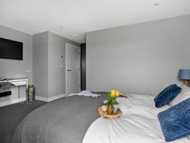 A bedroom with a bed and a television at Huxham View & Annex in Kingsteignton
