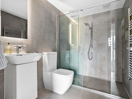 A bathroom with a shower, sink, and toilet at Huxham View & Annex in Kingsteignton