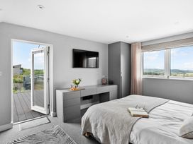 A bedroom with a bed and television at Huxham View & Annex in Kingsteignton