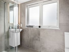 A bathroom with a shower, sink, and toilet at Huxham View & Annex in Kingsteignton
