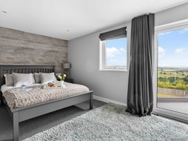 A bedroom with a bed and window at Huxham View & Annex in Kingsteignton