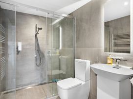A bathroom with a shower, toilet, and sink at Huxham View & Annex in Kingsteignton