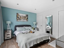 A bedroom with a bed and nightstand at Huxham View & Annex in Kingsteignton