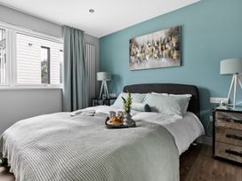 A bedroom with a bed and bedside table at Huxham View & Annex in Kingsteignton