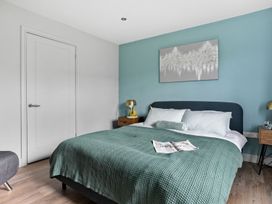 A bedroom with a bed and bedside tables at Huxham View & Annex in Kingsteignton