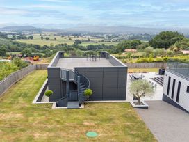 An outdoor area with a building featuring a rooftop and a spiral staircase at Huxham View & Annex Kingsteignton