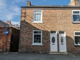 A brick house facade with windows and doors at Chapel Cottage in Filey