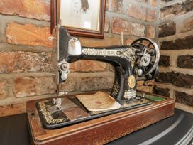 A sewing machine placed on a wooden table at Chapel Cottage in Filey