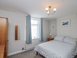 A bedroom with a bed and a bedside table at Chapel Cottage in Filey