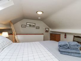 A bedroom with a bed and dresser at Chapel Cottage in Filey