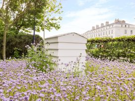 A beehive surrounded by flowers at Chapel Cottage in Filey