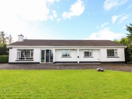A front view of a house with a garden at Cross Beg Kilmihil, County Clare