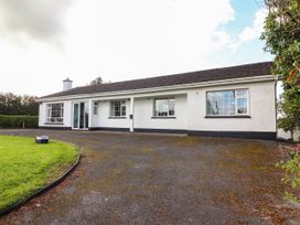 A house with a driveway and grass at Cross Beg, Kilmihil, County Clare