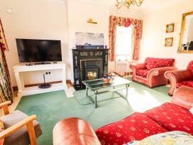 A living room with a television and a fireplace at Cross Beg in Kilmihil, County Clare