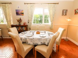 A dining room with a round table and chairs at Cross Beg Kilmihil, County Clare