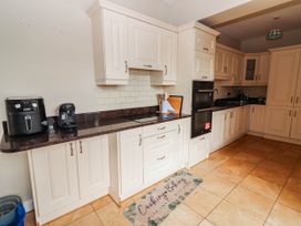 A kitchen with appliances and cabinets at Cross Beg in Kilmihil, County Clare