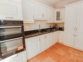 A kitchen with oven, sink, and kettle at Cross Beg in Kilmihil, County Clare
