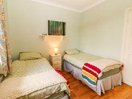 A bedroom with two beds and a nightstand at Cross Beg, Kilmihil, County Clare