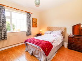 A bedroom with a bed and nightstand at Cross Beg, Kilmihil, County Clare