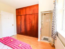 A bedroom with a wardrobe and shower at Cross Beg, Kilmihil, County Clare