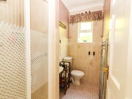 A bathroom with a shower, toilet, and sink at Cross Beg, Kilmihil, County Clare