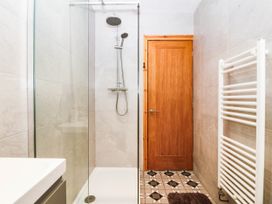 A bathroom with a shower and sink at Derwen-Las in Penmaenmawr