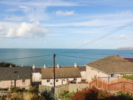 A view of the sea and houses from a hill at Derwen-Las in Penmaenmawr