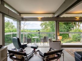 A living room with chairs and a table at Two Hoots Littleworth