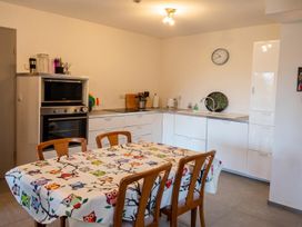A kitchen with a dining table and chairs at Two Hoots Littleworth