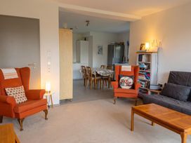 A living room with two armchairs and a sofa near a dining area at Two Hoots Littleworth