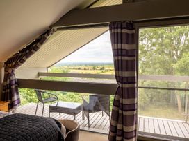 A bedroom with a window and view at Two Hoots Littleworth