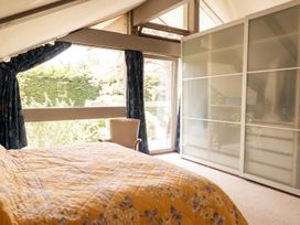 A bedroom with a bed and a sliding wardrobe at Two Hoots Littleworth