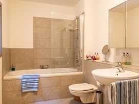 A bathroom with a bathtub and shower at Two Hoots Littleworth